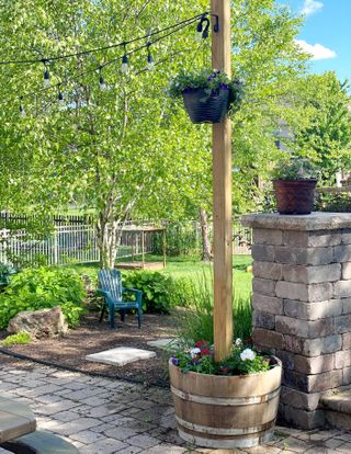 barrel planter holding string lights