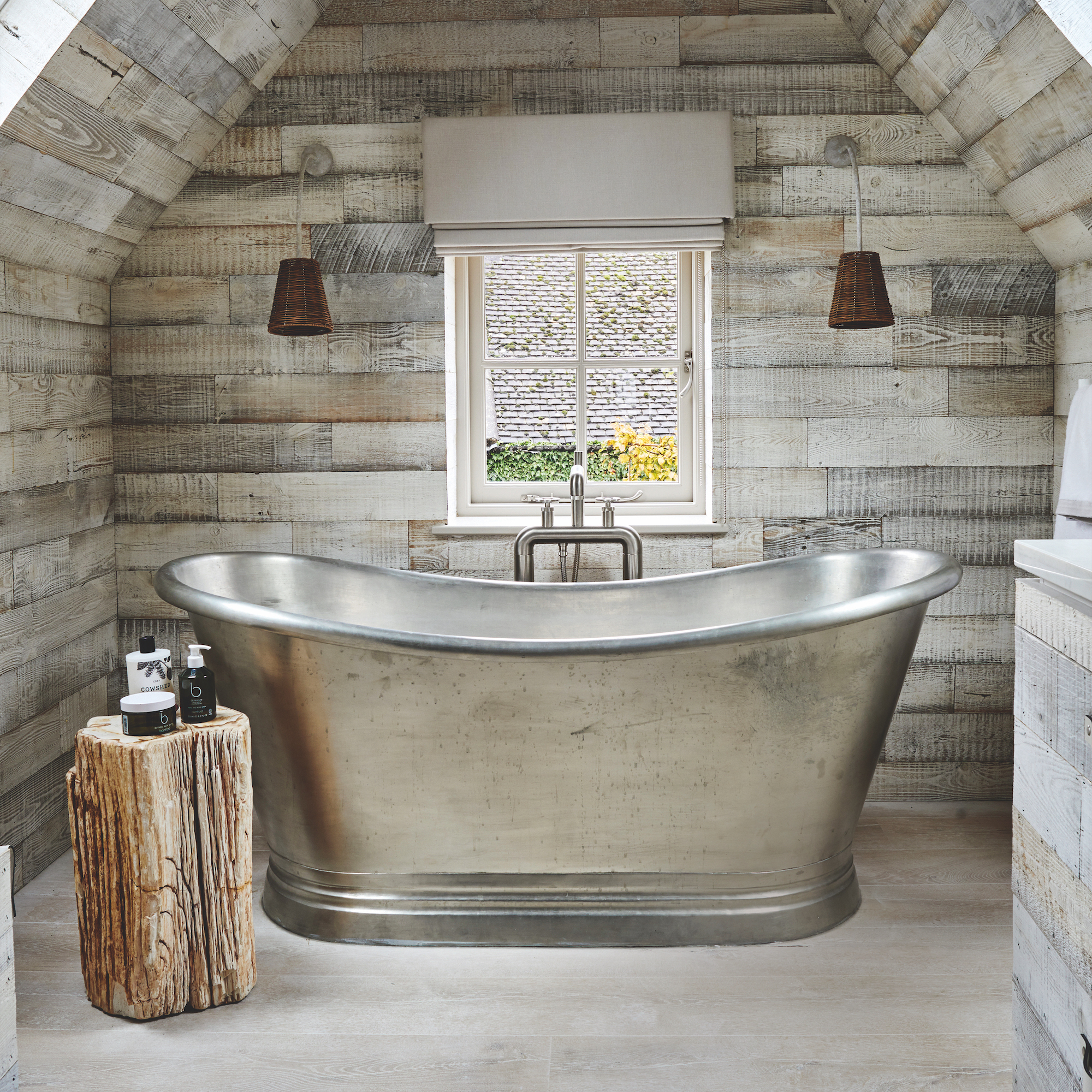 steel bath in rustic bathroom with wooden walls