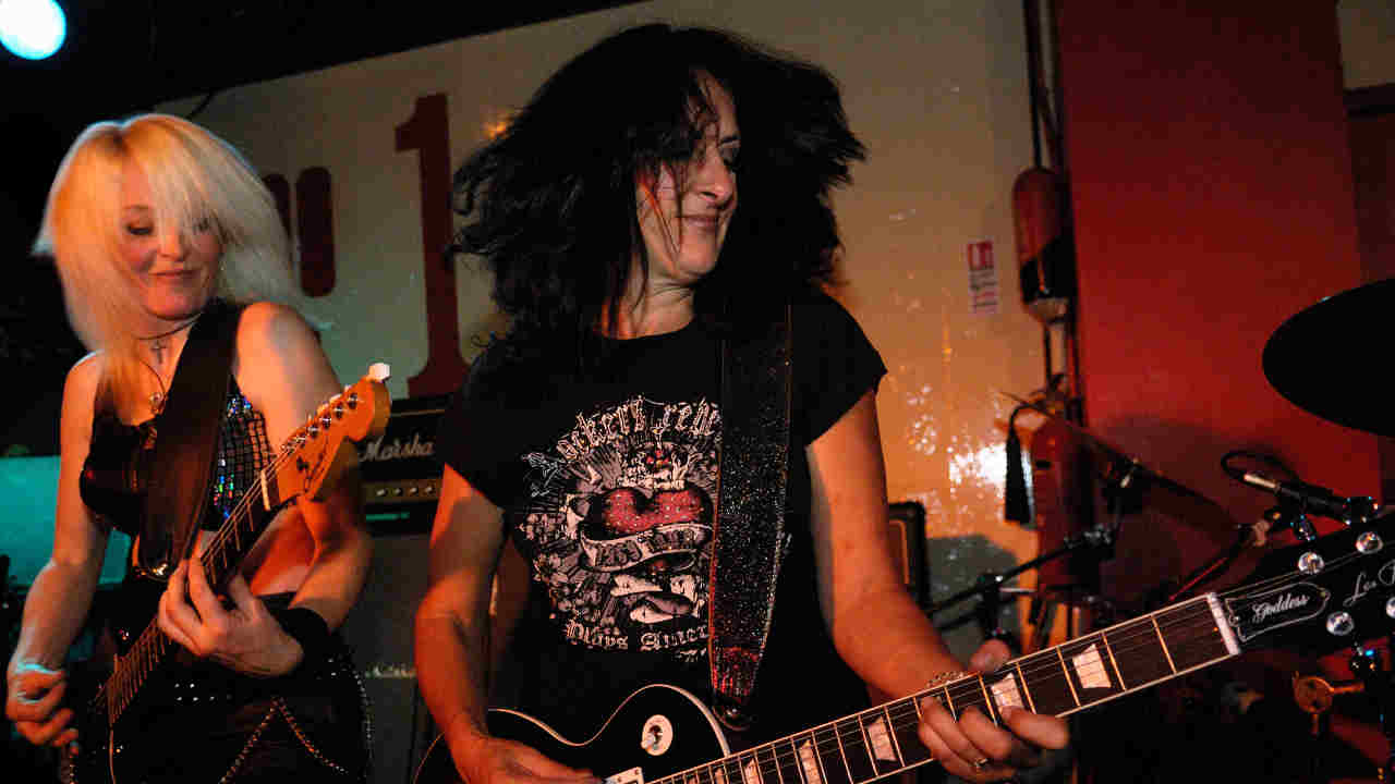Girlschool performing onstage in 2008