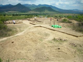 A view of structures 28 (left) and 27 (right), the buildings archaeologists believe were two priestly homes. The trench in the foreground exposes the original ground surface between the main temple and the homes.