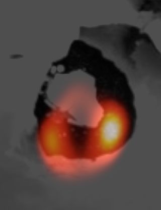 A Large Binocular Telescope image of Loki Patera, a lava lake on Jupiter's volcanic moon Io (orange), on top of an image of the same region by NASA's Voyager spacecraft several decades ago.