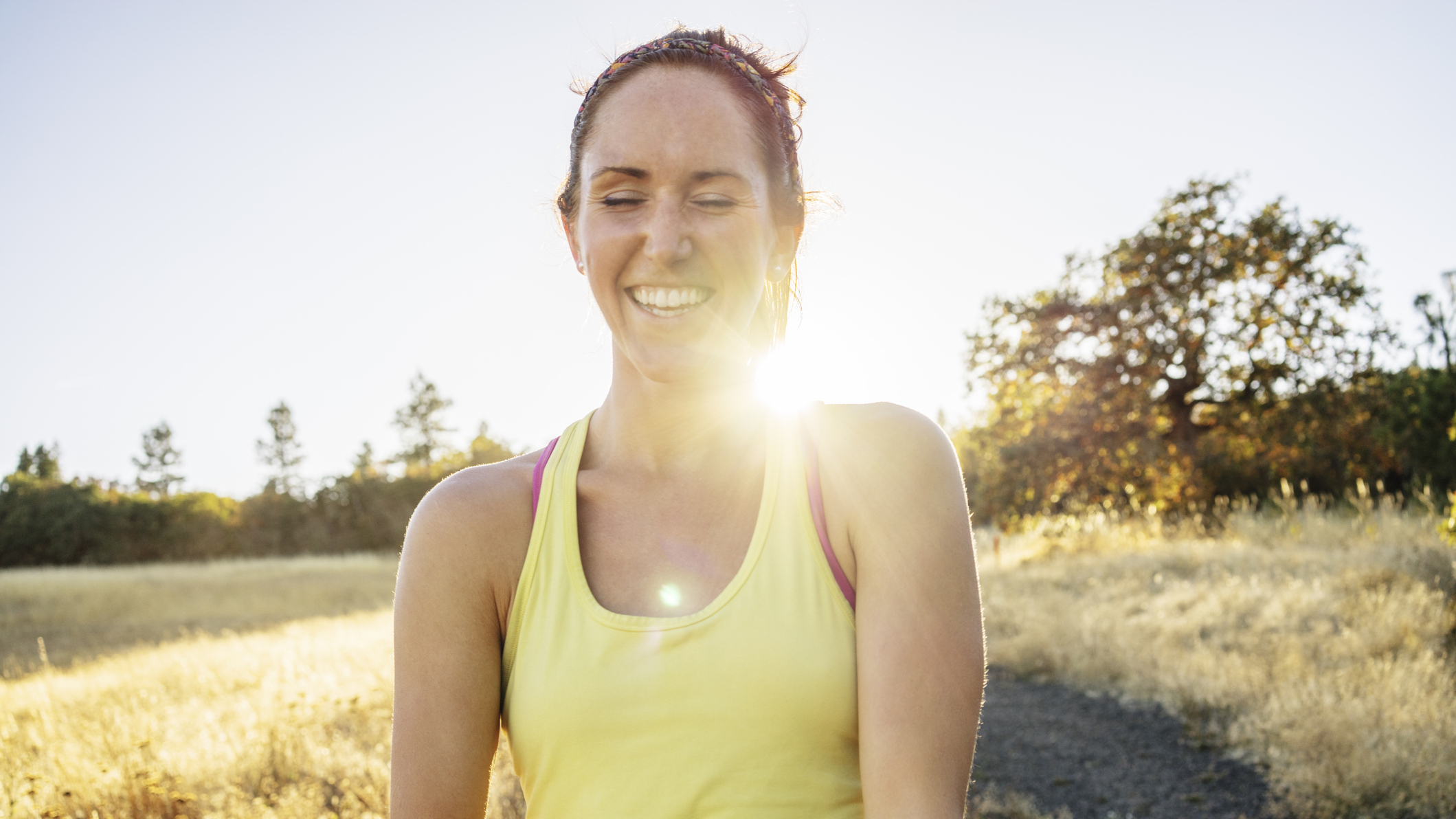 Smiling woman outdoors in vest top