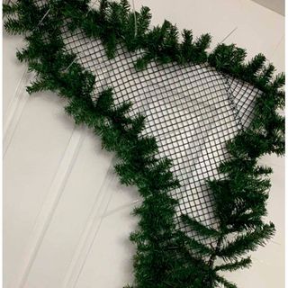 Chicken wire christmas decoration on a white door