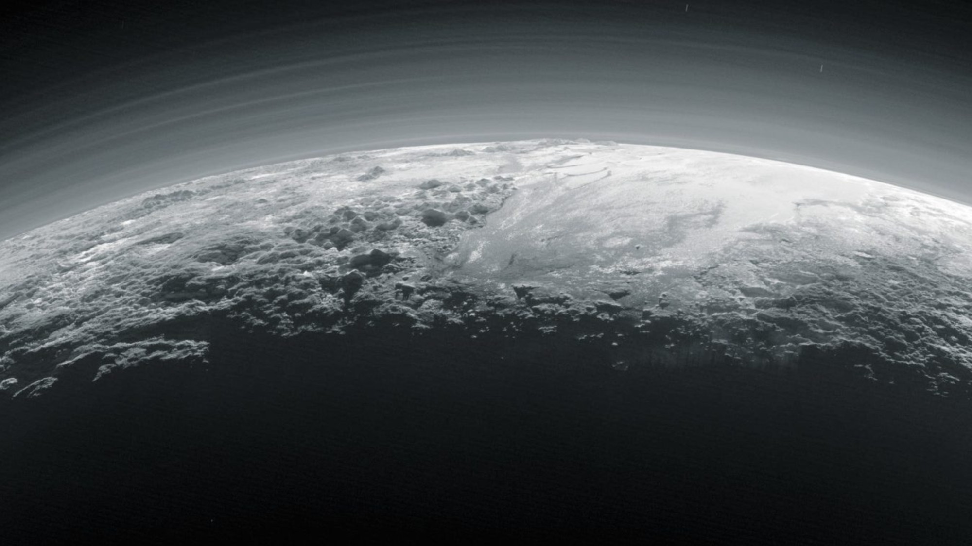 a hazy ring of gas surrounds a white rocky planet