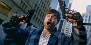 Daniel Radcliffe holding two guns in Guns Akimbo trailer shot