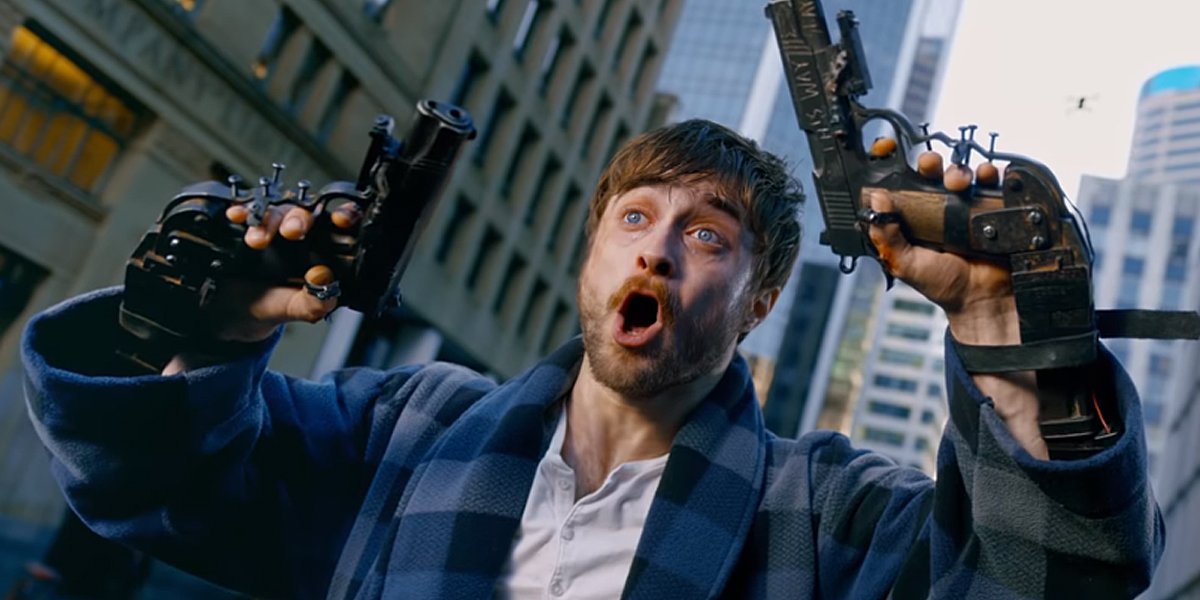 Daniel Radcliffe holding two guns in Guns Akimbo trailer shot