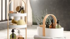 White plastic and light wood cleaning caddies with bathroom products