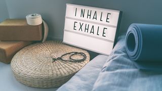 Sign on bedside table reads “Inhale Exhale“