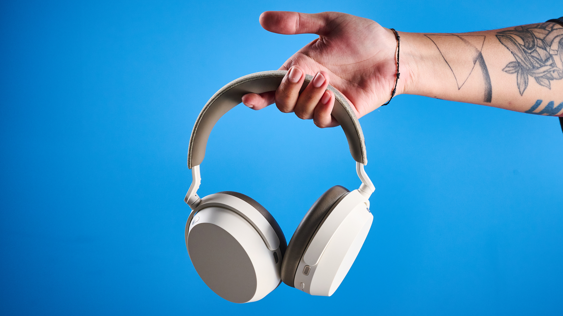 the sennheiser momentum 5 in white photographed against the blue tom's guide background