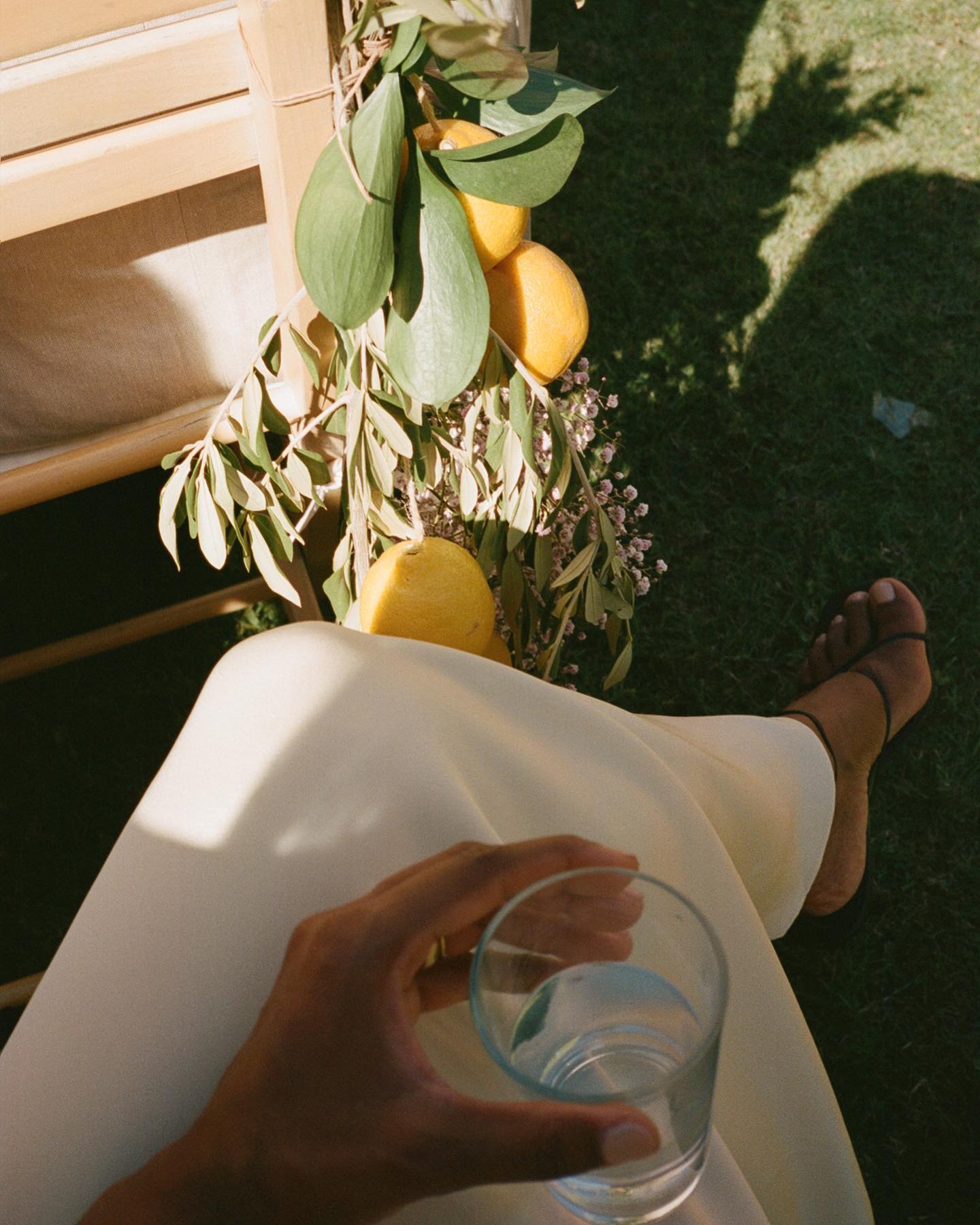 Monikh in a white dress with a neutral pink pedicure colour