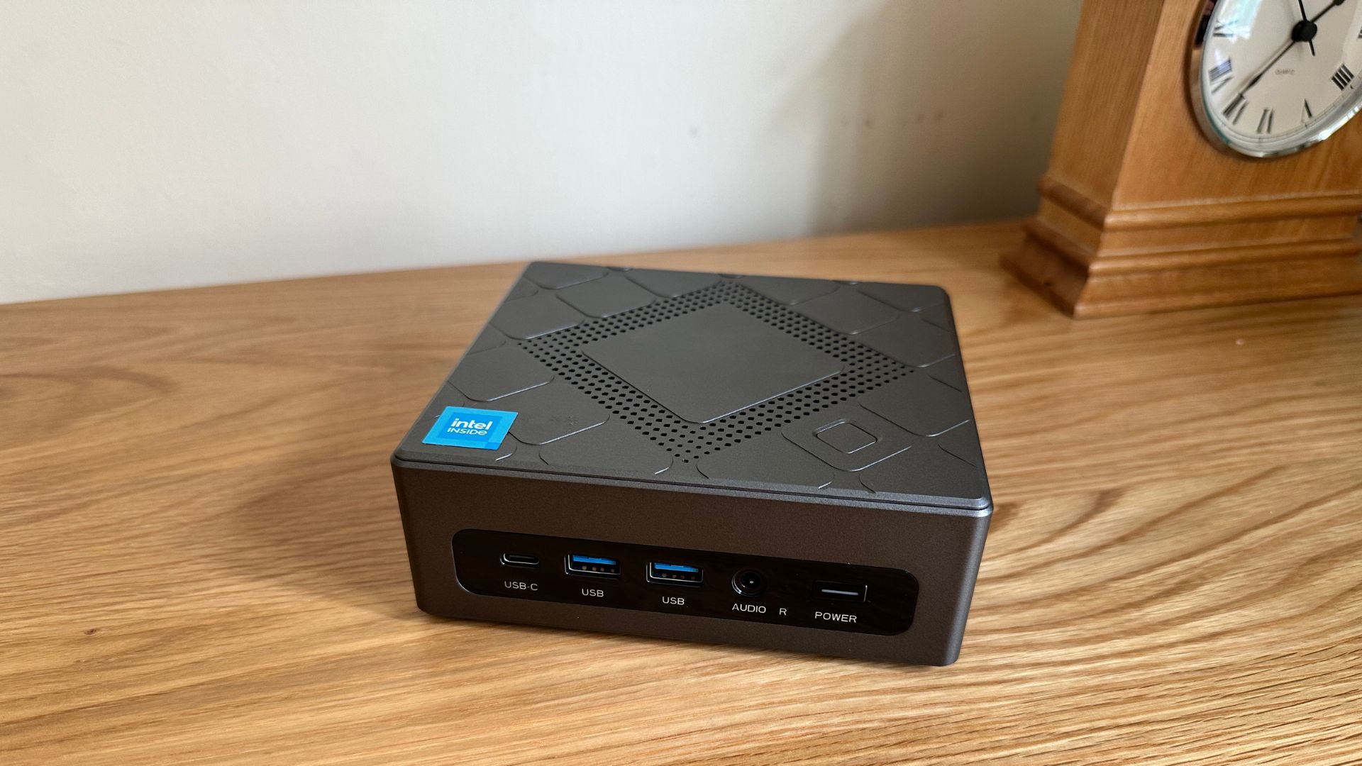 AceMagician CK10 mini PC on a wooden sideboard