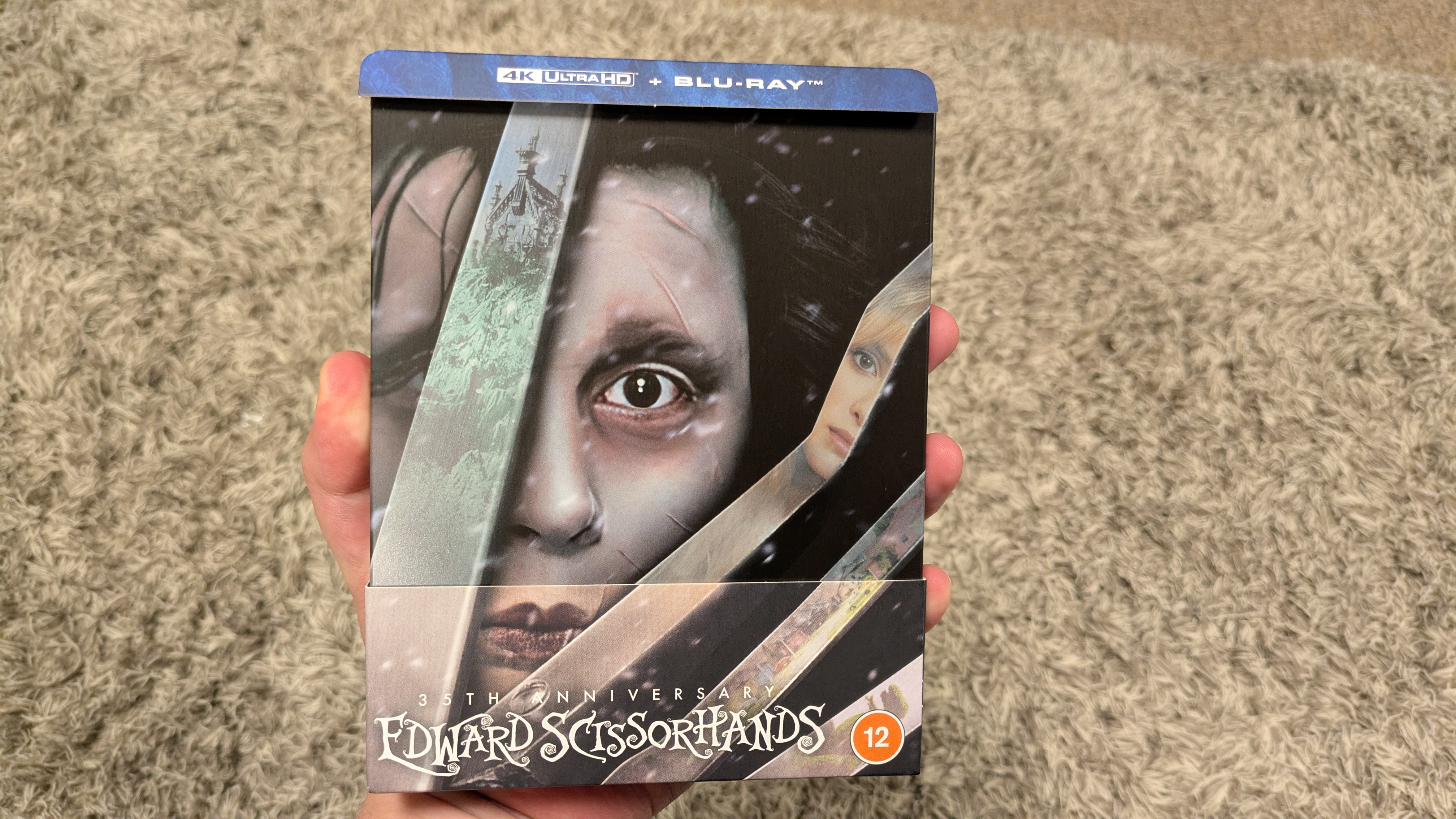 Edward Scissorhands 4K Blu-ray showing a yellow car and colorful houses on LG G5 