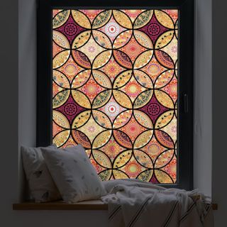 Stained glass window film in red, orange, and yellow colors with a boho pattern
