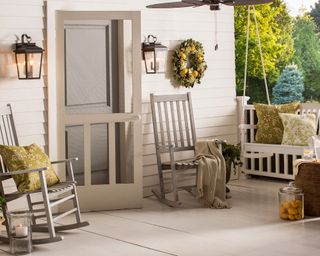 Front porch ideas by Wayfair with grey rocking chair and bench, wreath and pendant light
