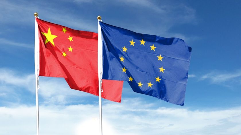 China flag and EU flag on cloudy sky. Waving in the sky