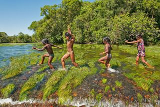 Kayapo indigenous children from Brazil play in water