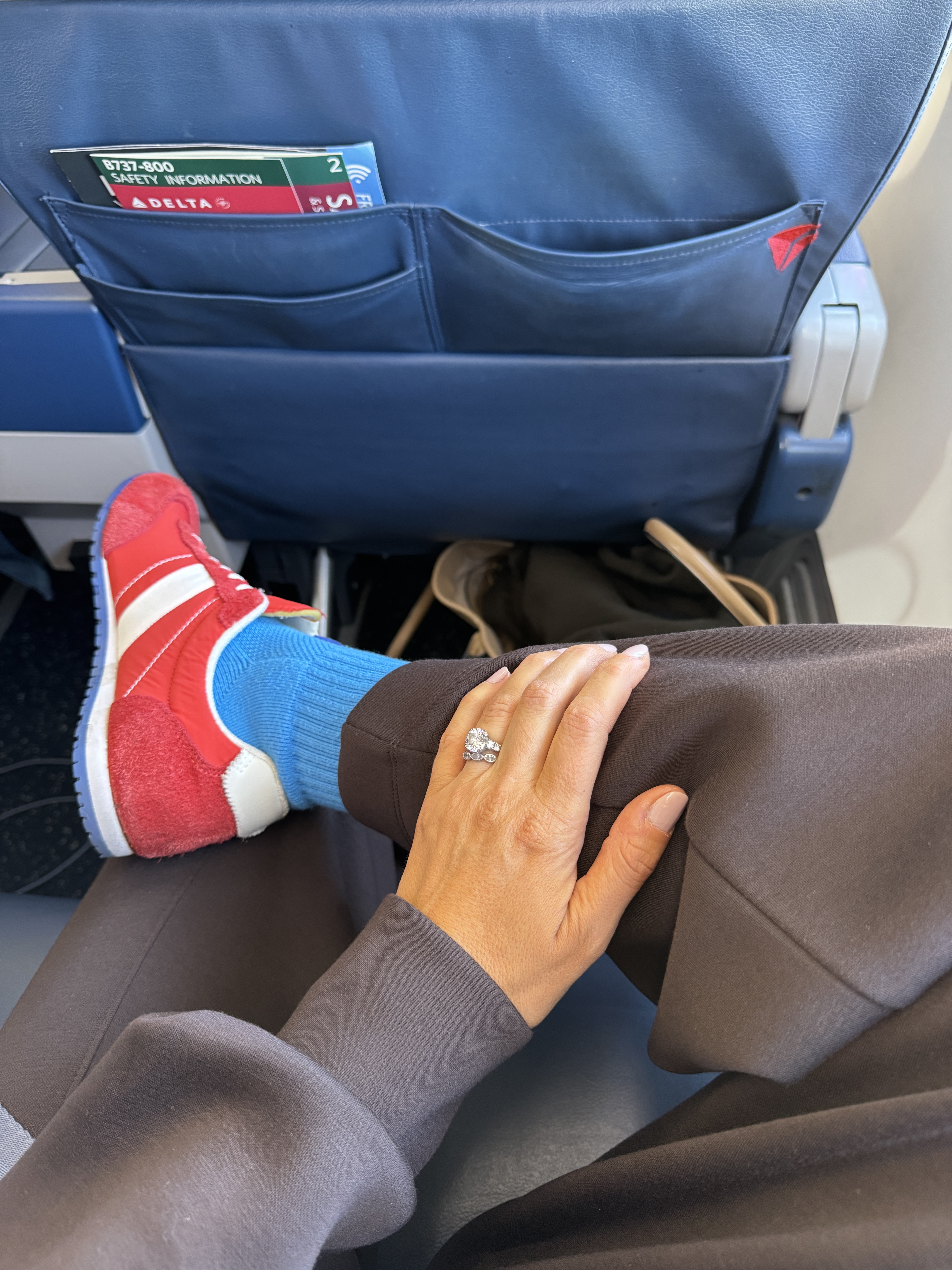 Woman in red slim sneakers and blue socks