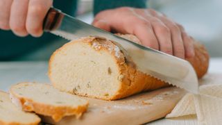 Bread being sliced with a bread knife