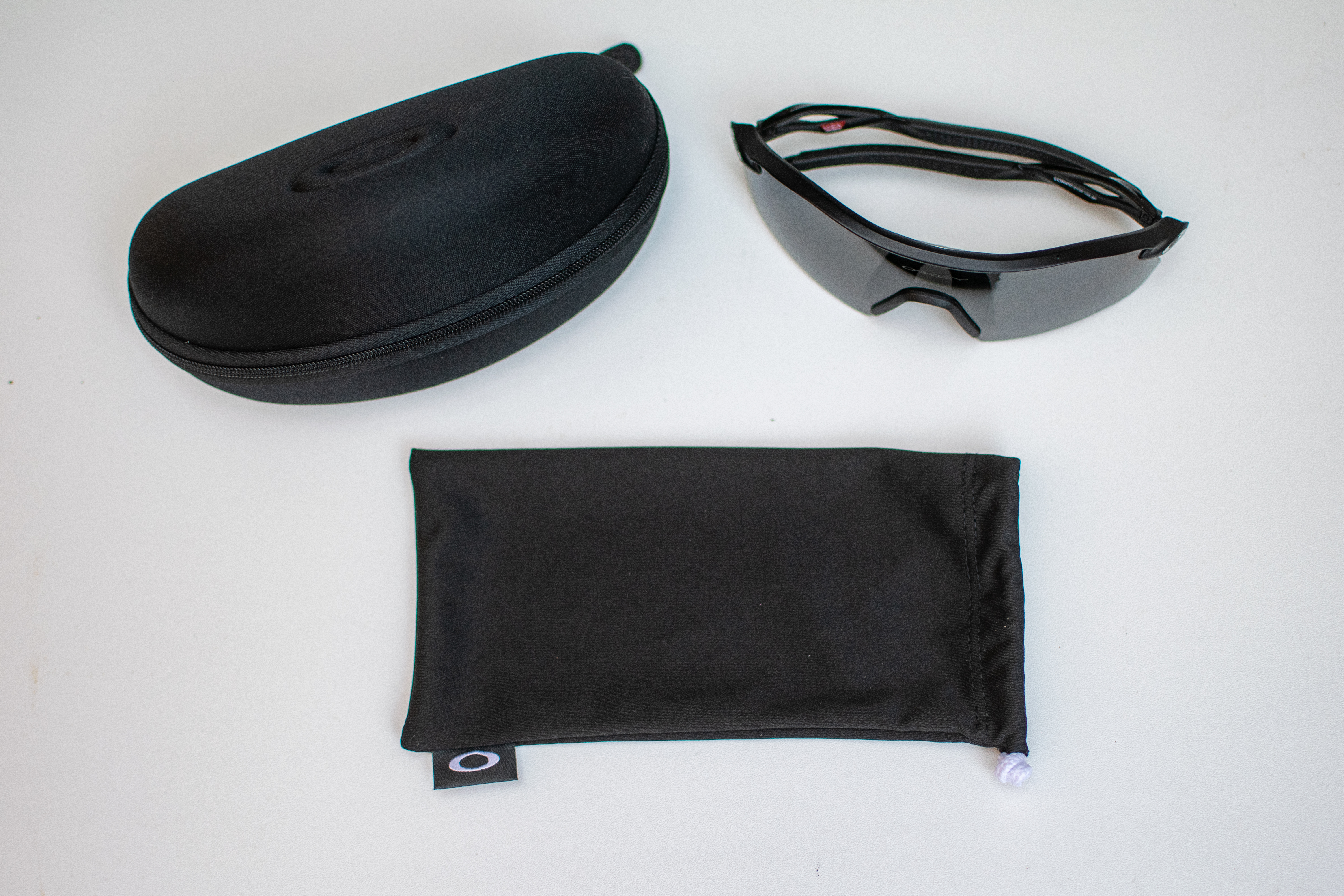A man wearing a pair of black Oakley Radar Plates