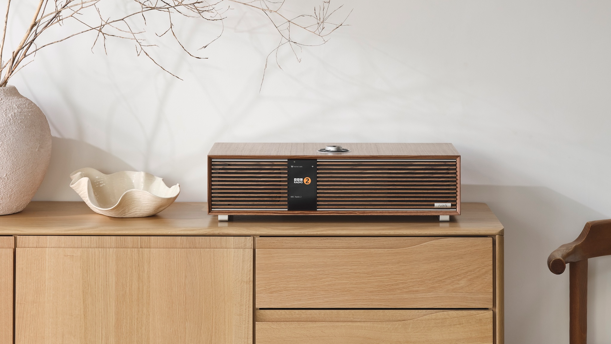The Ruark R410 atop a light wood sideboard