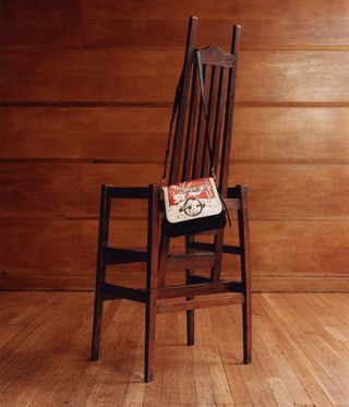 Handbag hanging on dark wooden chair