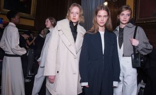 Ladies with their black and white overcoats