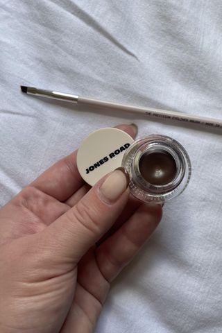 Valeza holding the gel liner pot and application brush