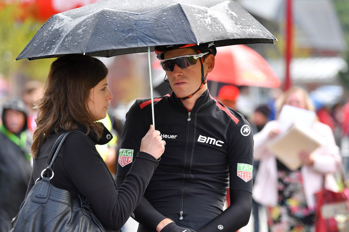 Ben Hermans is kept safe from the rain by his wife