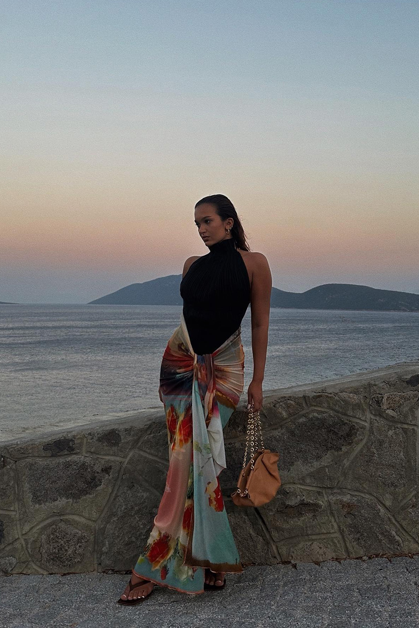 European vacation outfit idea is shown in a photo of a woman