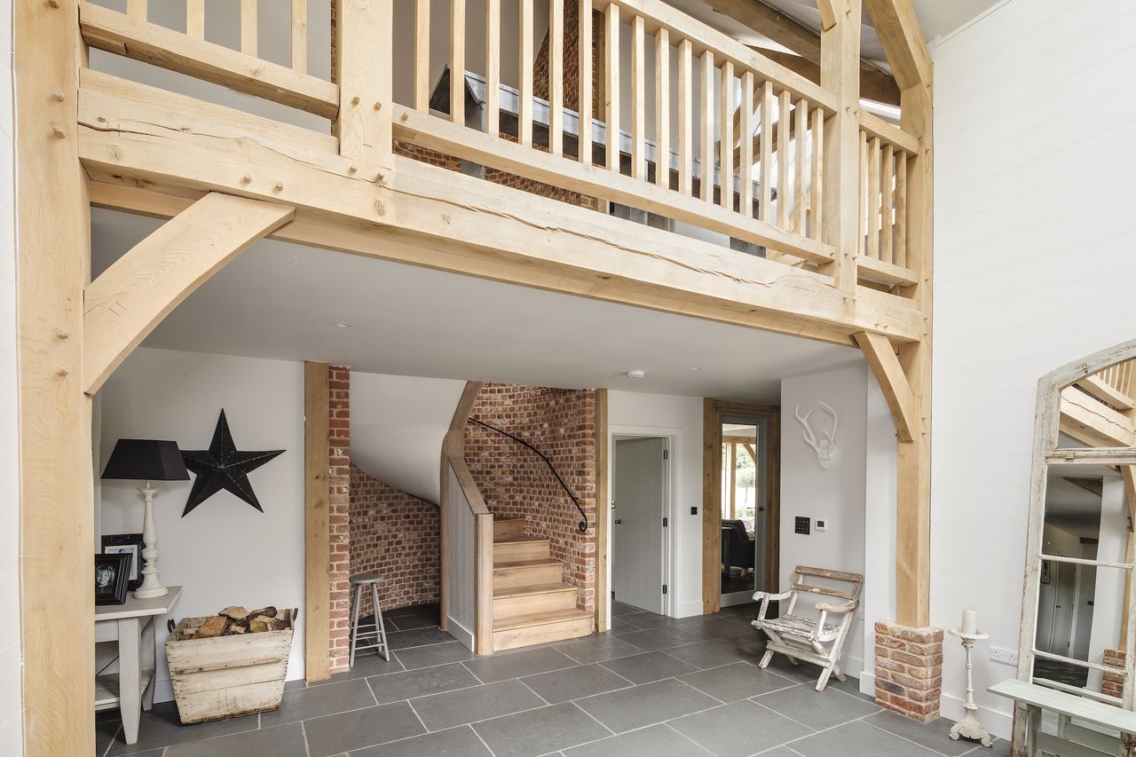 brick curved staircase with galleried landing above
