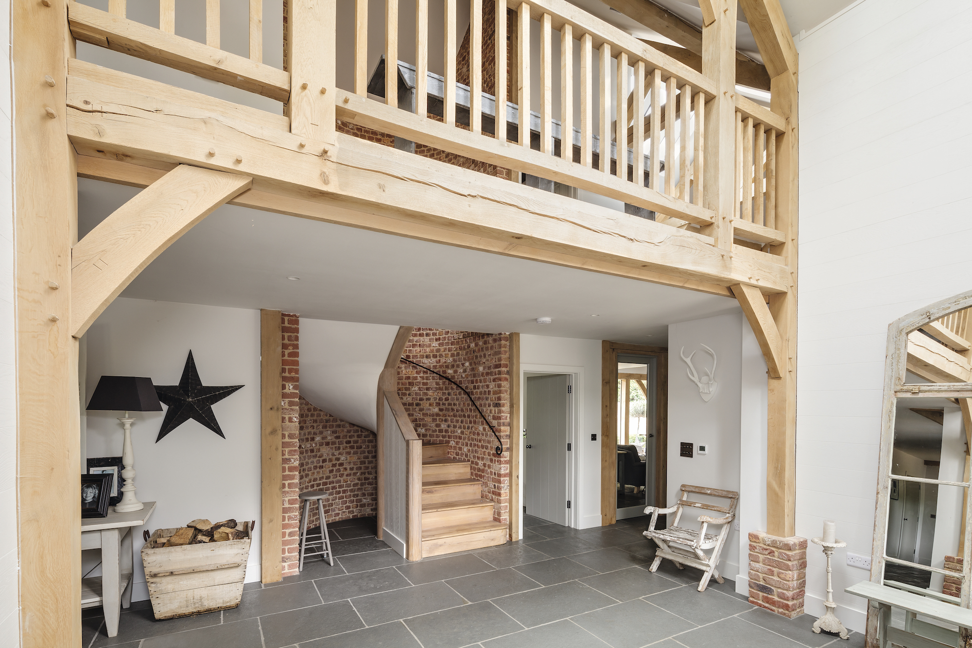 brick curved staircase with galleried landing above