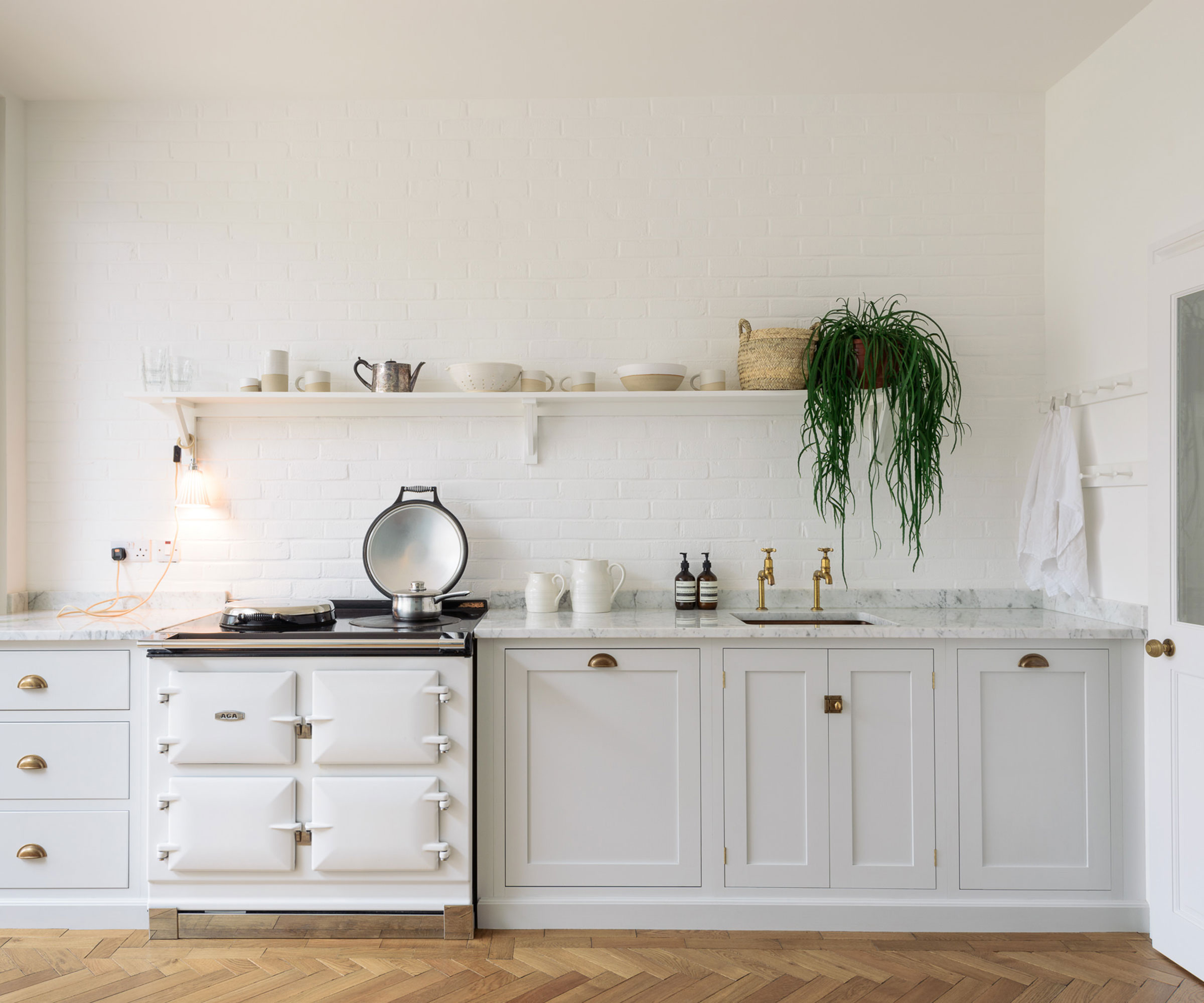 modern off-white Shaker kitchen with open shelving and AGA