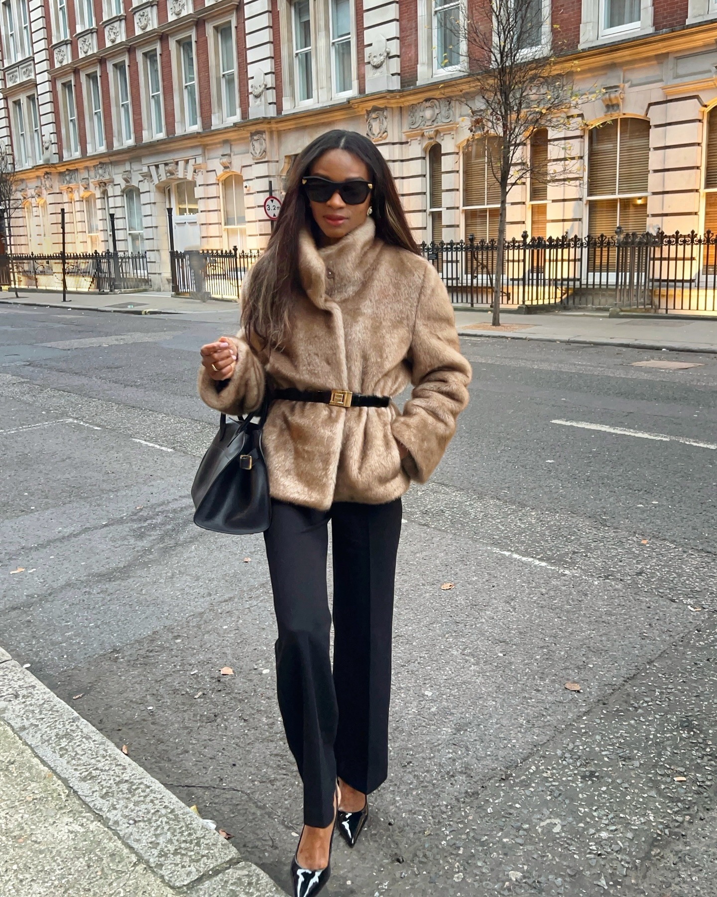Woman in faux fur jacket and black pants
