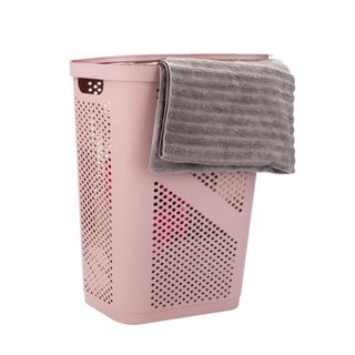 A pink laundry hamper with a towel