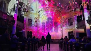 People watching a lightshow inside St Martin-in-the-Fields church
