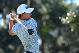 Maverick McNealy hits a tee shot with a fairway wood