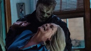 Jamie Lee Curtis as Laurie Strode being attacked by Michael Myers in Halloween Ends