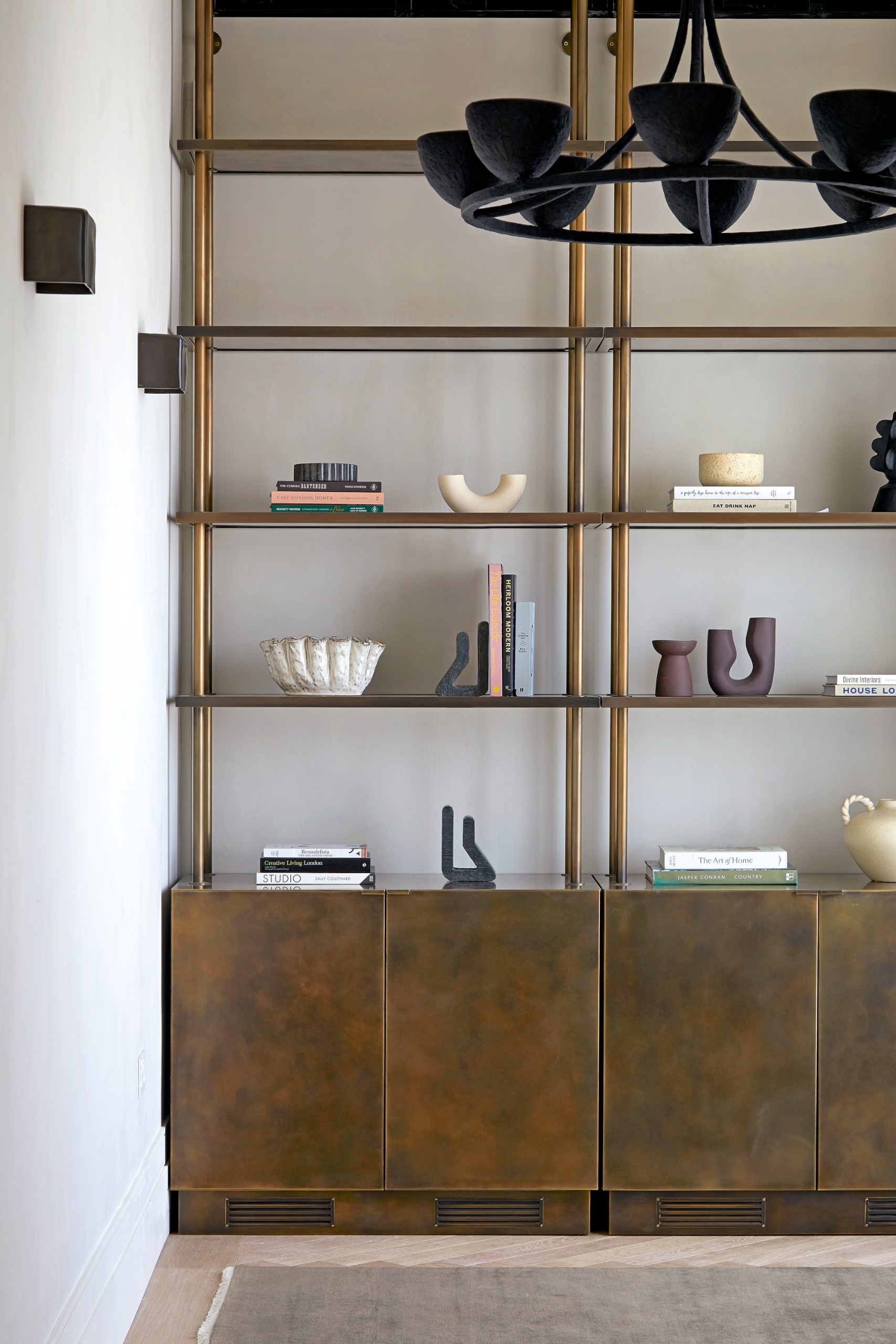 Burnished brass joinery with closed cupboards and open shelving