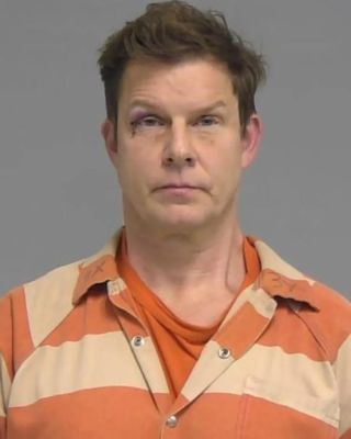 Eric Mabius in orange and cream striped jumpsuit after arrest, mug shot courtesy of Sheriff's Office.