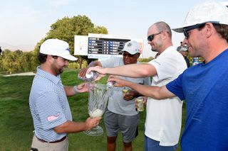 Greyson Sigg and his friends pour beer into a trophy