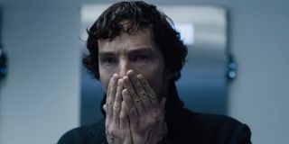 Sherlock covering his mouth with his hands