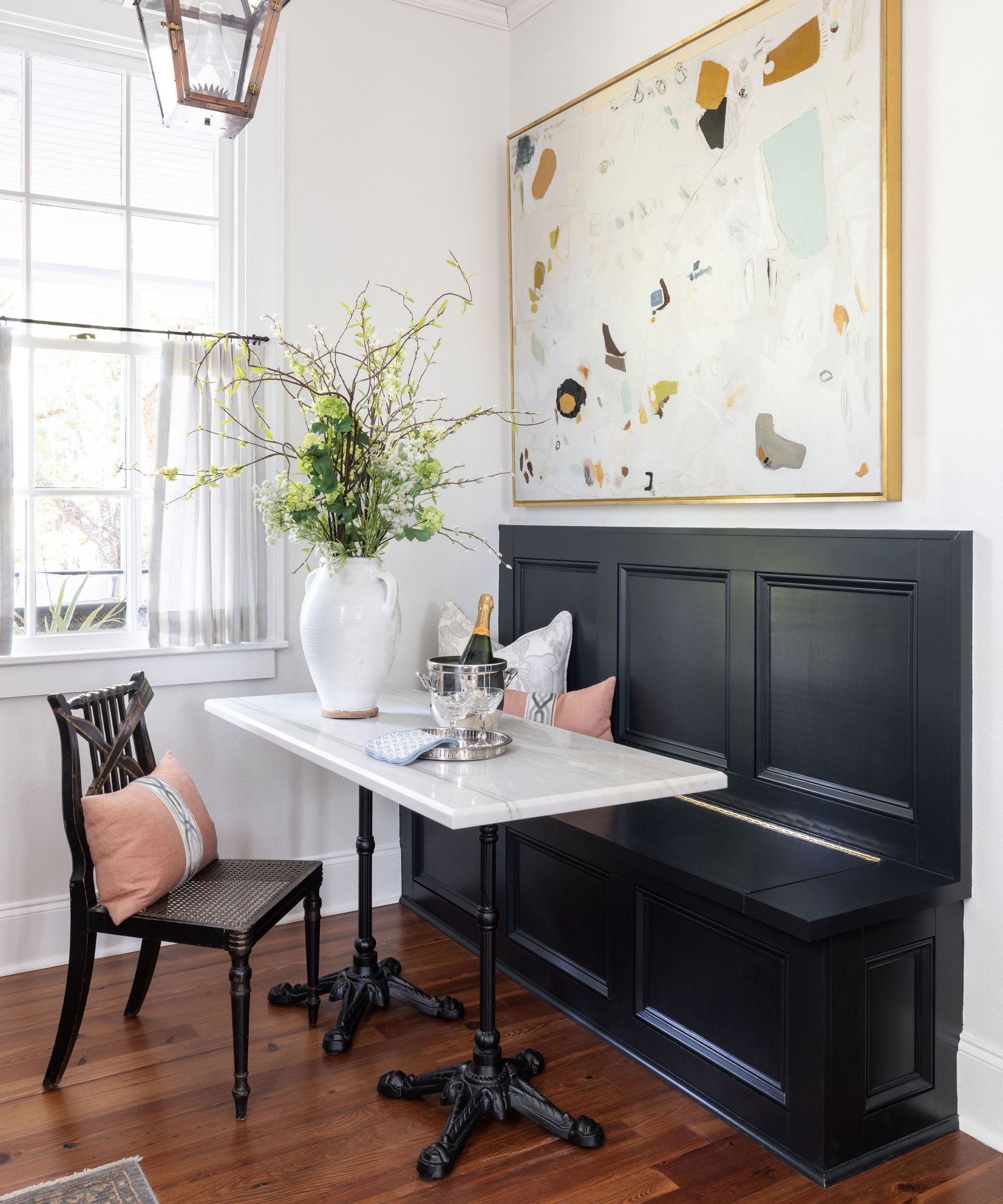 Cozy nook with table and cafe curtains on window