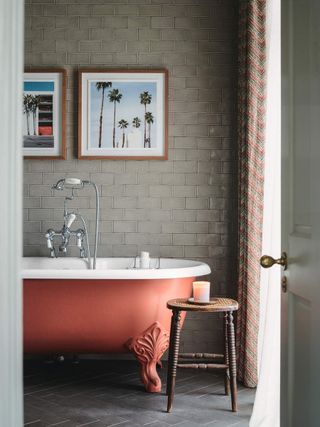 clay colored roll top bath in beige bathroom