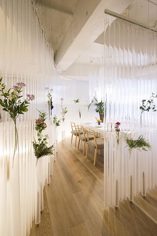 waves of cylinders with floral attachments in restaurant dining area