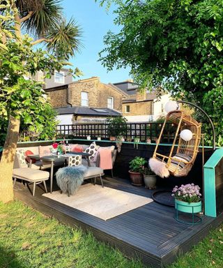 A small decking idea with vintage egg chair, L-shaped sofa design with colorful cushions