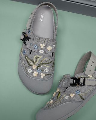 A robust rubber upper, industrial hardware buckle and feature delicate floral embroidery