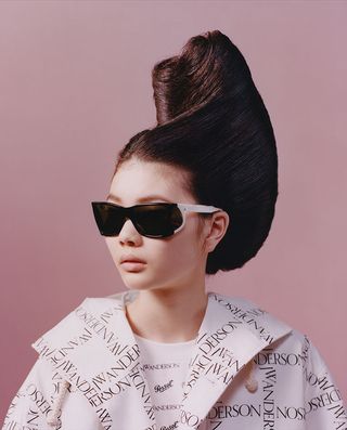 Female model wears JW Anderson x Persol 0009 sunglasses