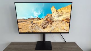 Huawei Mateview SE review: computer monitor on wooden desk with landscape image