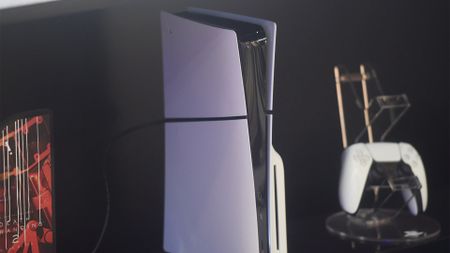 the PlayStation 5 with its controller in the background