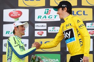 Geraint Thomas (R) shakes hands with Spain's Alberto Contador on the podium